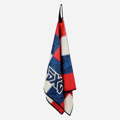 PXG stars and stripes players golf towel with patchwork colors of blue, white, and red on a white background