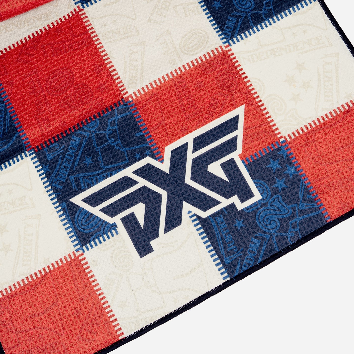 PXG stars and stripes players golf towel with patchwork colors of blue, white, and red on a white background