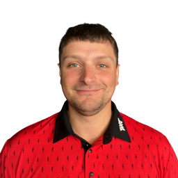 A man wearing a red short-sleeve polo shirt with a black collar and a small repeating black logo pattern, photographed against a plain white background.