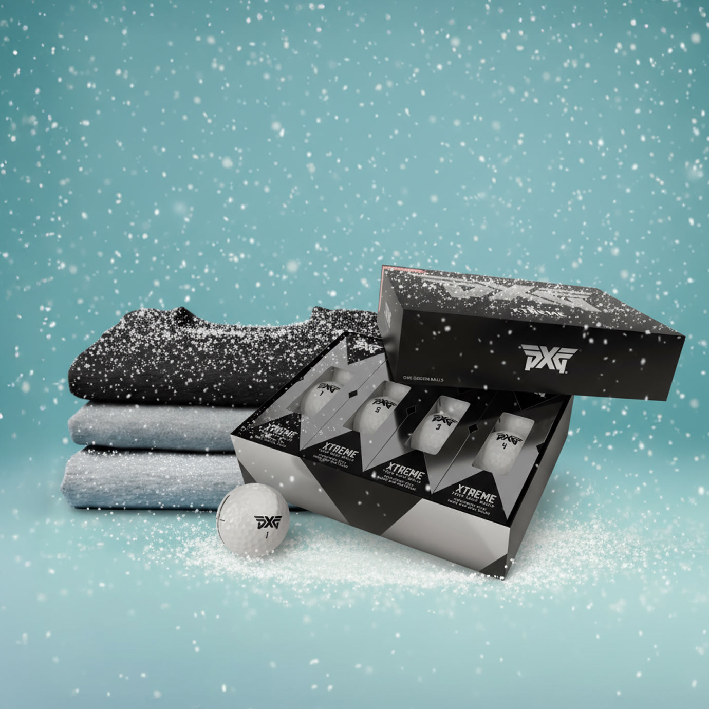 Golf products including towels, balls, and boxes with 'Xtreme' branding on a snowy background.