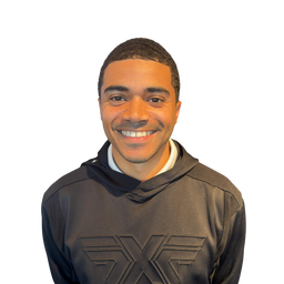 A smiling man wearing a dark gray athletic hoodie with a large embossed logo on the chest, isolated on a white background.