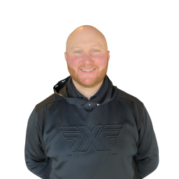 A smiling bald man with a beard wearing a black athletic hoodie with a tonal embossed logo on the chest, set against a plain white background.