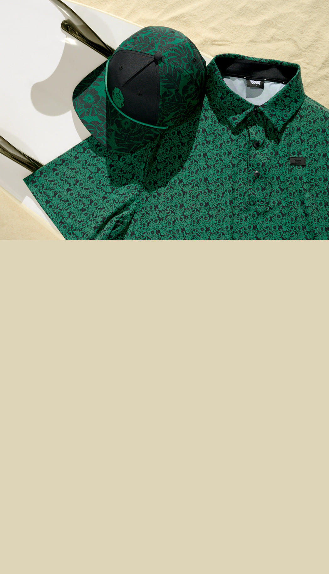 Green patterned shirt with a black cap on a beige background