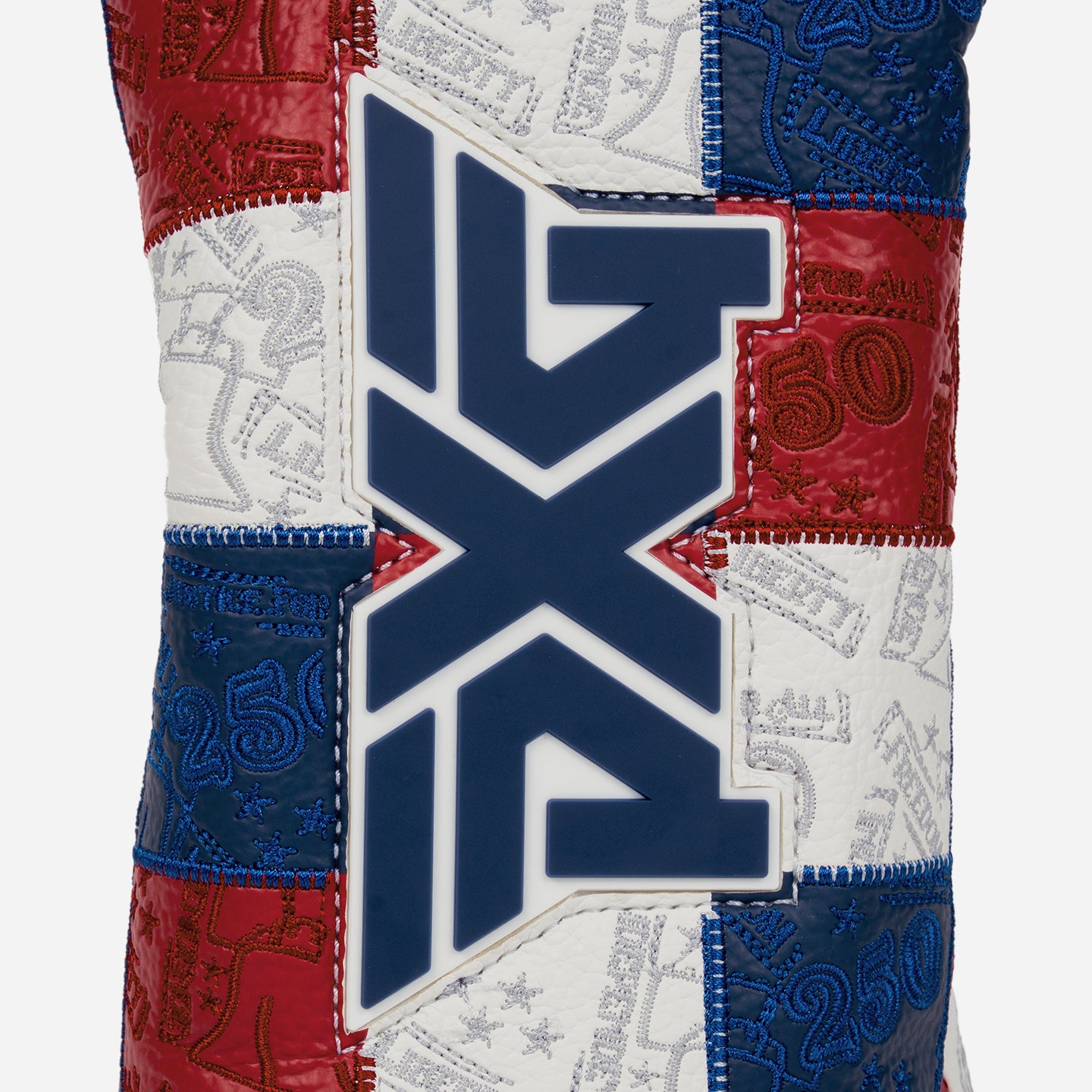 Driver headcover with patchwork colors of blue, white, and red and a blue PXG logo on a white background
