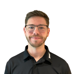 A man with short brown hair, glasses, and a light beard wearing a black button-up shirt, photographed against a plain white background.