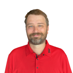 A man with a beard and short brown hair wearing a bright red button-up shirt, photographed against a plain white background.