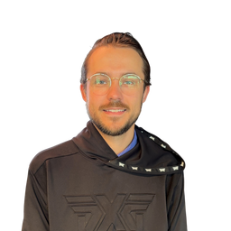 A man with glasses and a short beard wearing a dark brown hooded sweatshirt with a large embossed logo on the chest, photographed against a plain white background.
