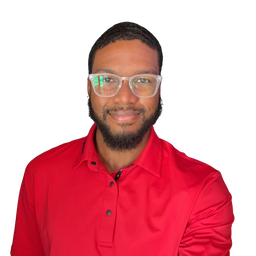A man wearing clear-framed eyeglasses and a bright red polo shirt, shown from the chest up against a plain white background.
