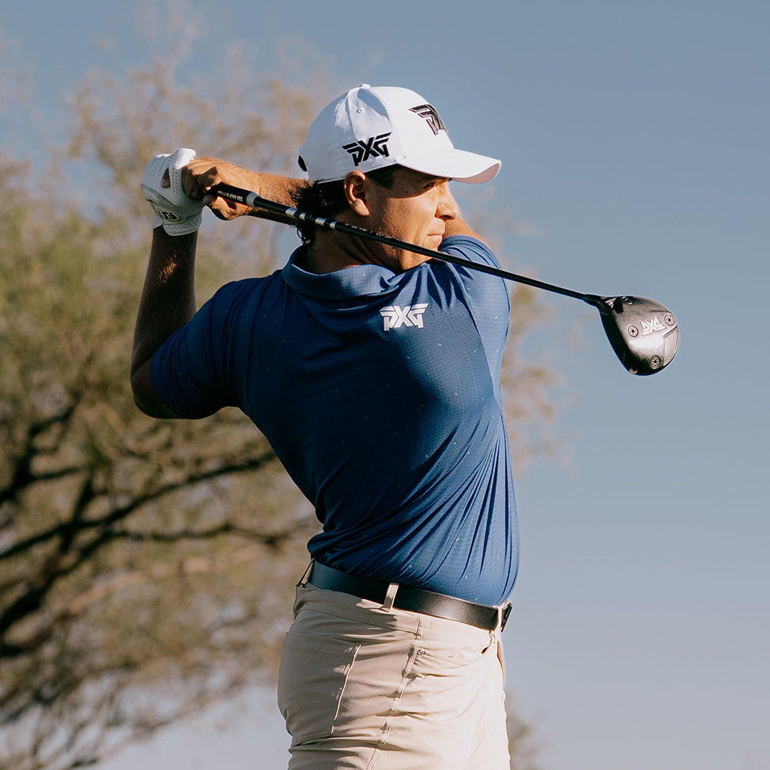 PGA Tour Aldrich Potgieter swinging a PXG golf club wearing a PXG golf shirt and hat.