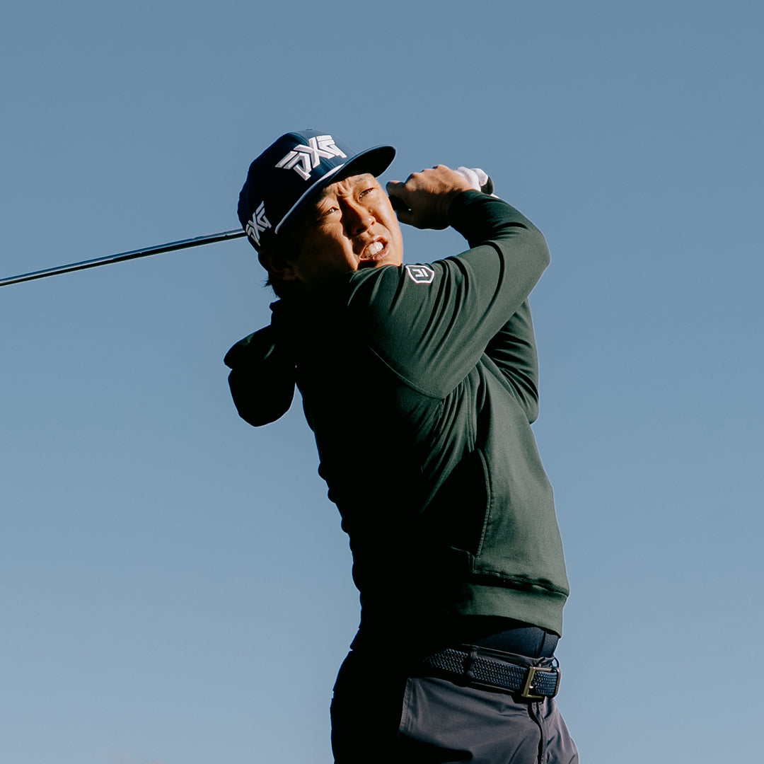 PGA Tour Pro David Lipsky wearing PXG Golf Hat against a clear blue sky