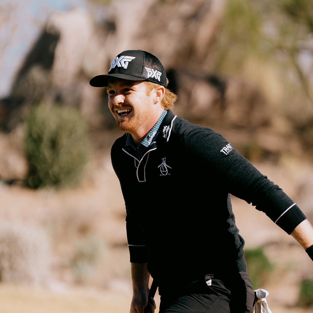Tour Pro Mason Anderson wearing a PXG hat on a golf course.