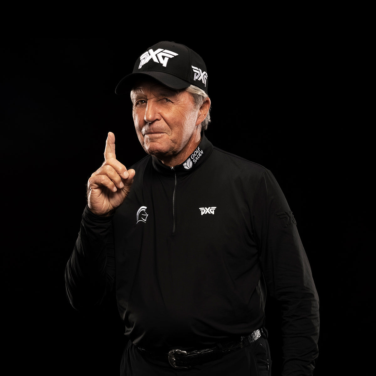 Gary Player wearing a black cap and jacket with PXG logo on a black background