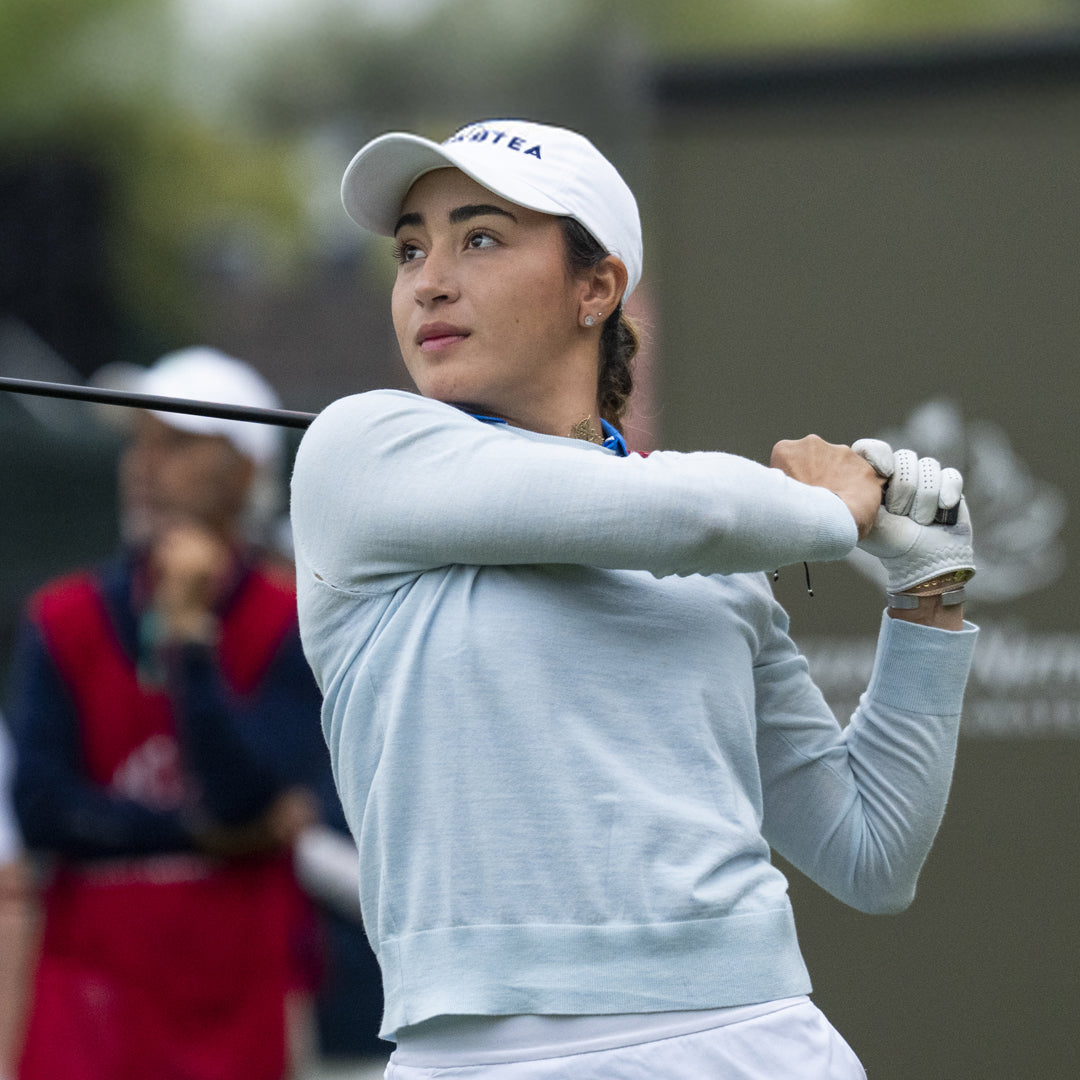 Lauren Olivares, pro golfer, swinging a golf club.