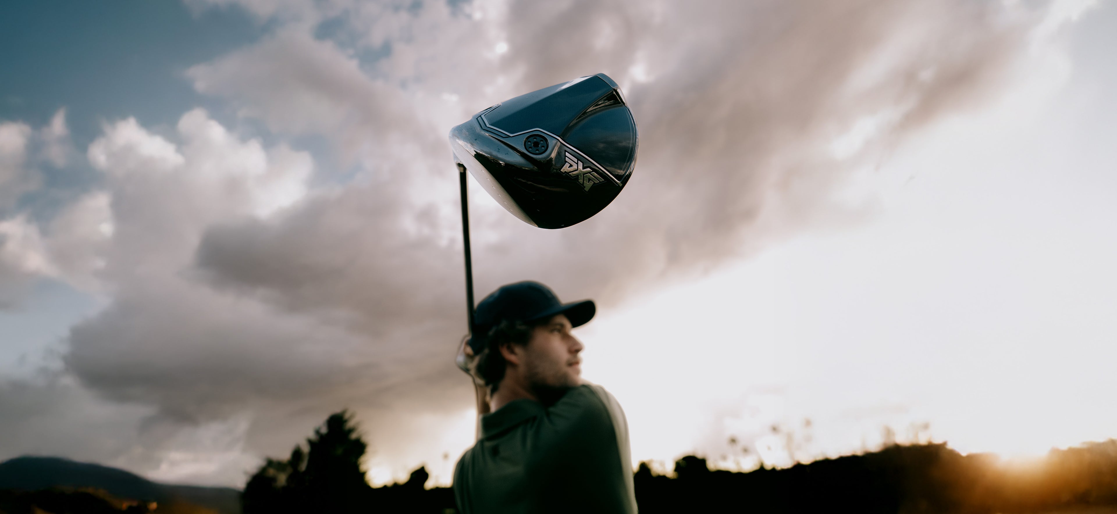 Person holding a golf club with a scenic background