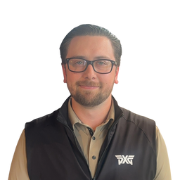 A man with glasses and a beard wearing a black zip-up vest over a tan button-down shirt, featuring a white logo on the left chest, set against a plain white background.