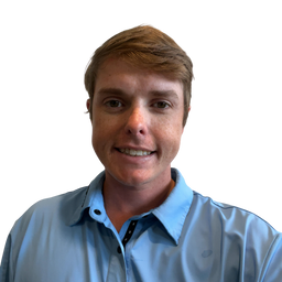 A smiling man with light brown hair wearing a light blue button-up shirt, photographed against a solid white background.