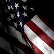 Close-up of an American flag with stars and stripes.