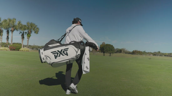 Marco Penge walking on a golf course with his PXG golf bag. 