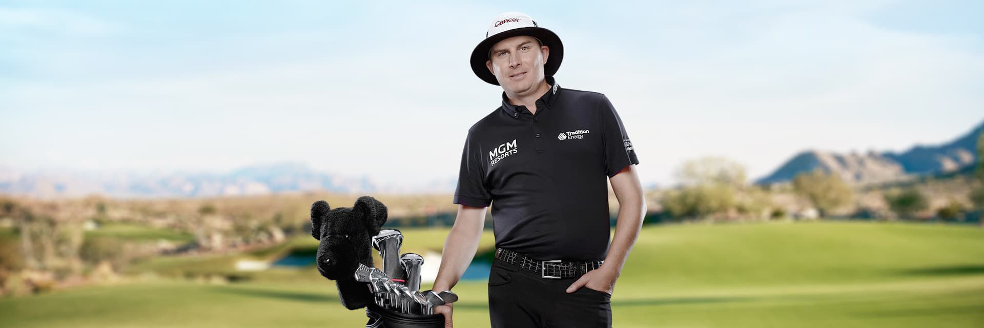 PXG PGA TOUR Pro Joel Dahmen on the course with his golf bag.