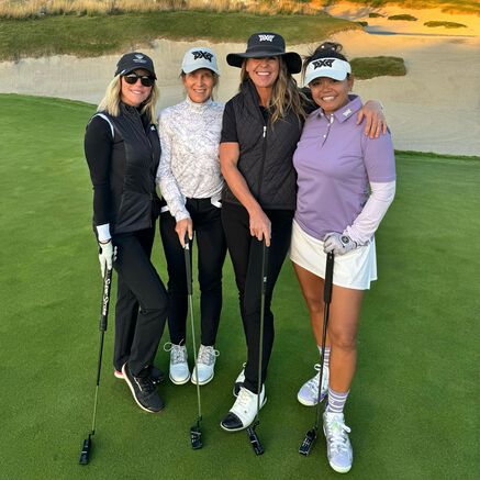 Renee Parsons on golf course green with golf putter and friends