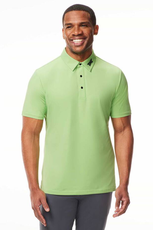Model in Green Polo and Gray Pants