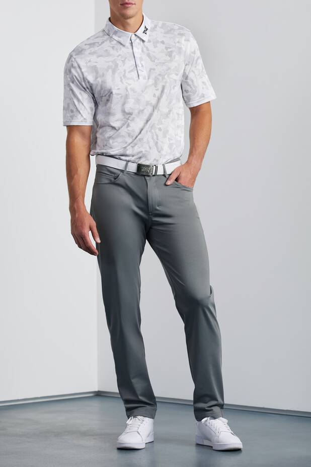 Model wearing White Polo with gray pants
