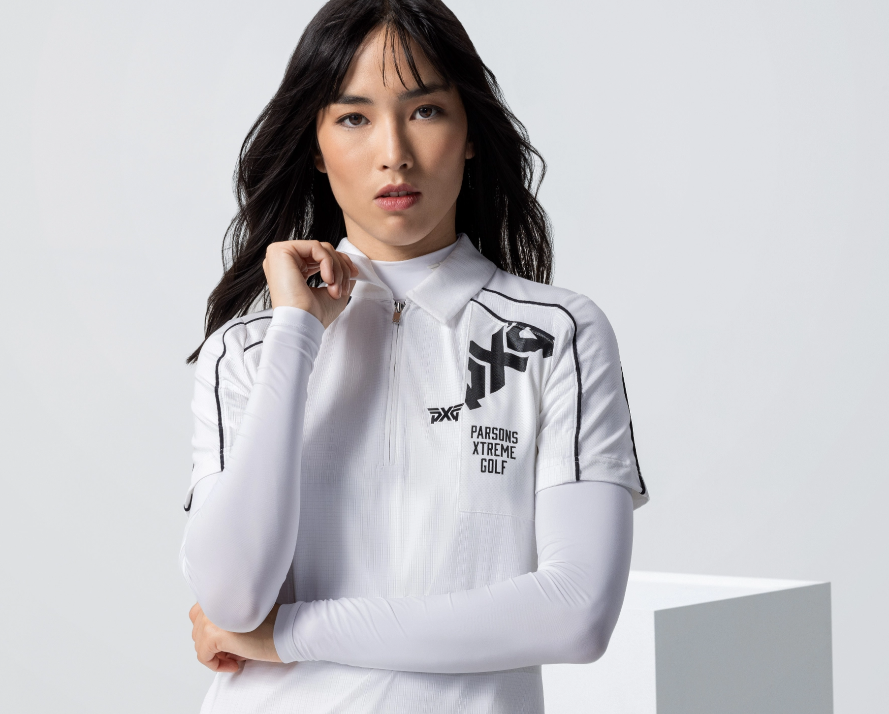 Woman in New fall white polo with while base layer on.
