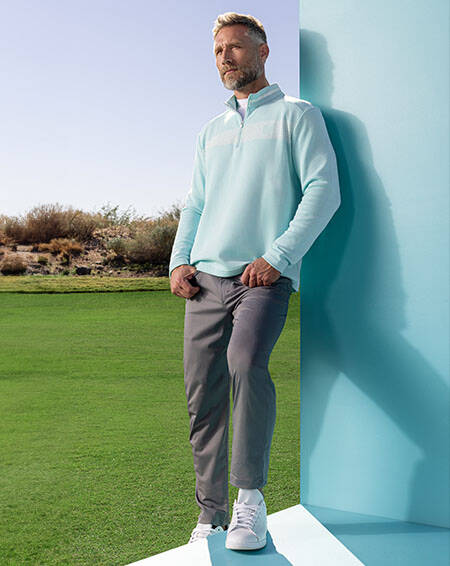 man in slim trousers and golf pullover