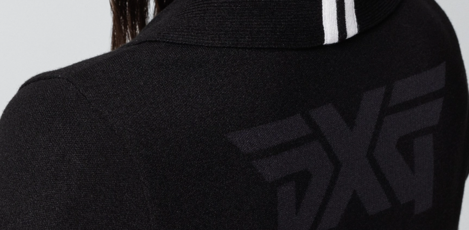 Close up of PXG logo on back of black Rolled Collar Cardigan