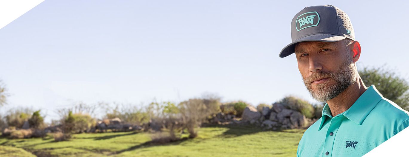 man with hat on golf course in pxg apparel and accessories